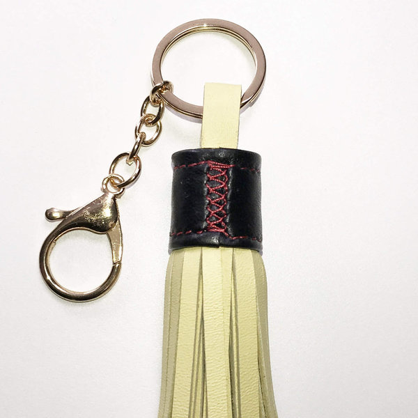 Schlüsselanhänger SERIE LUX. Leder Tassel Vanille Gelb mit Schwarzer Blende und goldfarbenen Details
